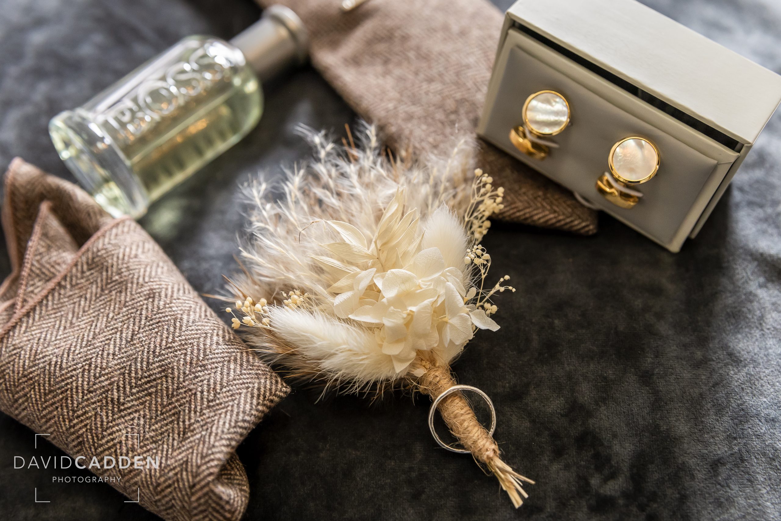 Groom details at Healing Manor, Grimsby, featuring cufflinks, boutonnière, aftershave, and pocket square.