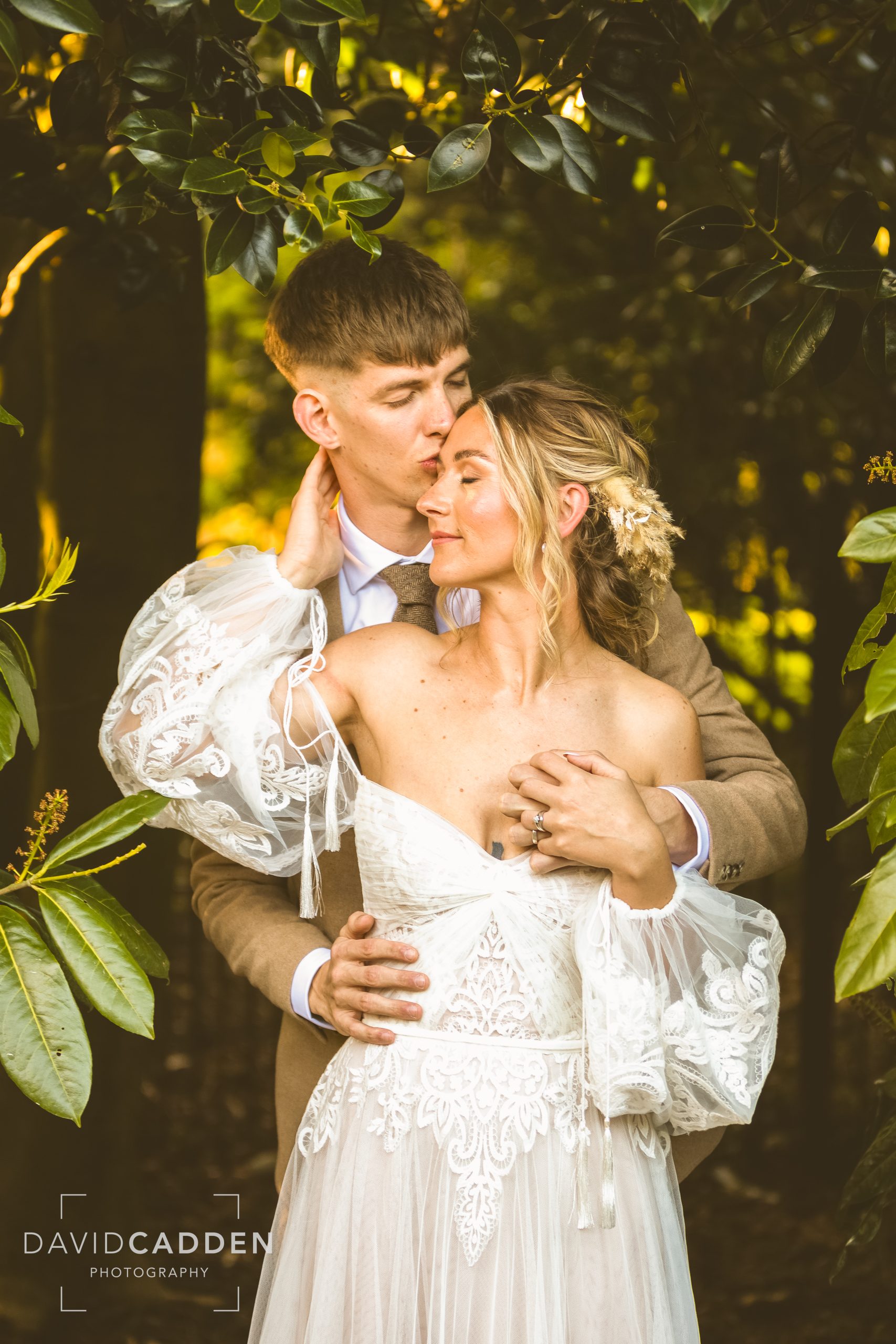 Bride and groom posing at Healing Manor, Grimsby, Lincolnshire wedding venue, with soft sunlight gently illuminating them.