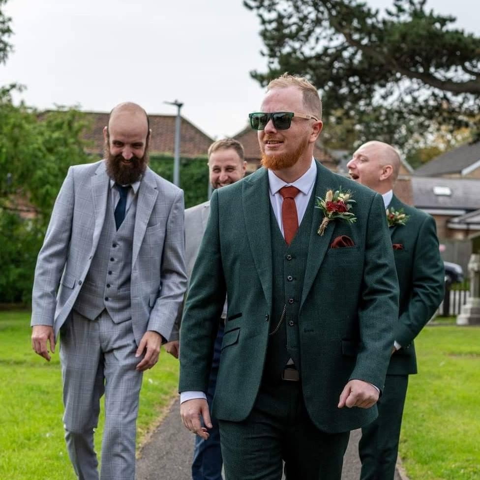 David Cadden walking with a wedding party before the ceremony, showing the relaxed approach he brings as a Mid North Coast wedding photographer.